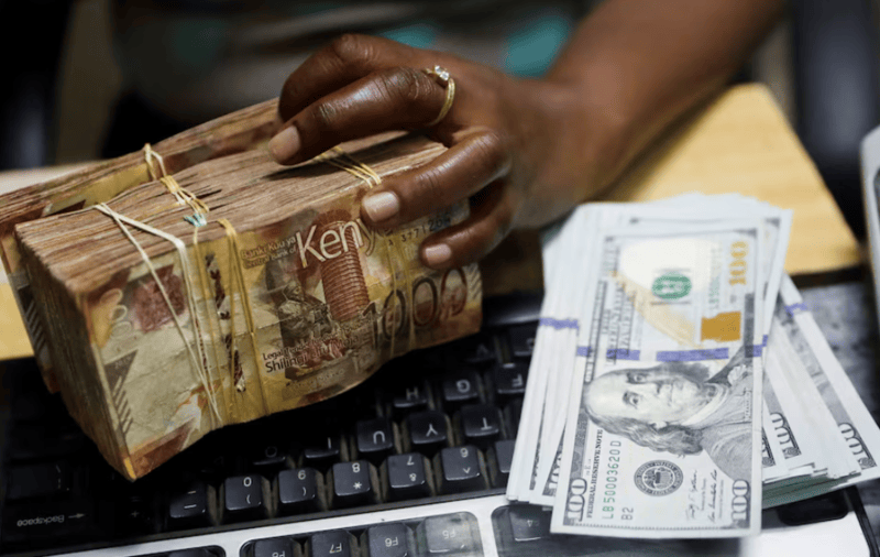 Kenyan shilling unchanged against dollar, LSEG data shows - A teller handles Kenya shilling banknotes and U.S. dollar banknotes inside the cashier's booth at a forex exchange bureau in downtown Nairobi, Kenya, February 16, 2024. (Photo: REUTERS)