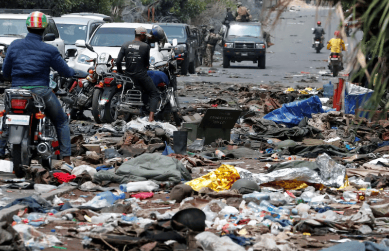 South Africa's military reinforces besieged DRC mission - Motorcycle taxi operators look at military uniforms and ammunition from the Armed Forces of the Democratic Republic of the Congo (FARDC) lying on the ground, amid clashes between them and the M23 rebels, in Goma, eastern Democratic Republic of the Congo, January 30, 2025. REUTERS