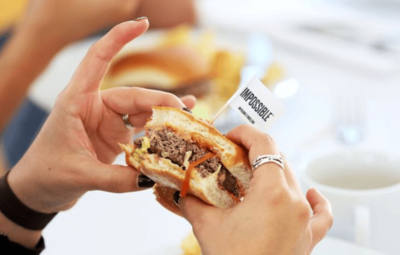 Science of flavour: Why do we crave certain foods more than others? - A woman eating a burger. (Reuters)