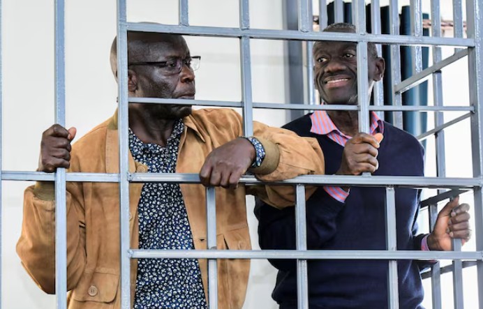 Besigye rushed to hospital after staging hunger strike in prison - Opposition leader Kizza Besigye and Obeid Lutale stand in a steel dock at the Uganda Military General Court Martial in Makindye, a suburb of Kampala, Uganda December 2, 2024. (Photo: REUTERS Abubaker Lubowa)