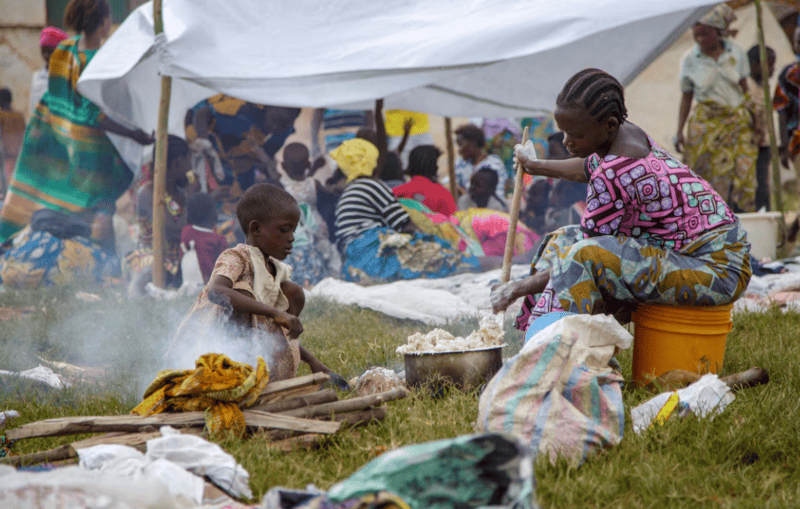 Agency warns of food shortages as Congolese refugee numbers surge - A Congolese woman prepares a meal near a temporary shelter at Rugombo Stadium, after fleeing from renewed clashes between M23 rebels and the Armed Forces of the Democratic Republic of the Congo (FARDC), in Rugombo commune of Cibitoke Province, Burundi February 18, 2025. REUTERS