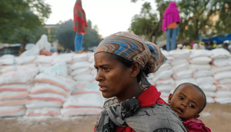 UN projects $2 billion for Ethiopia's 2025 humanitarian response, faces $496 million funding gap - A woman carries an infant in the town of Shire,Ethiopia, March 15, 2021. (Photo: Baz Ratner, Reuters)
