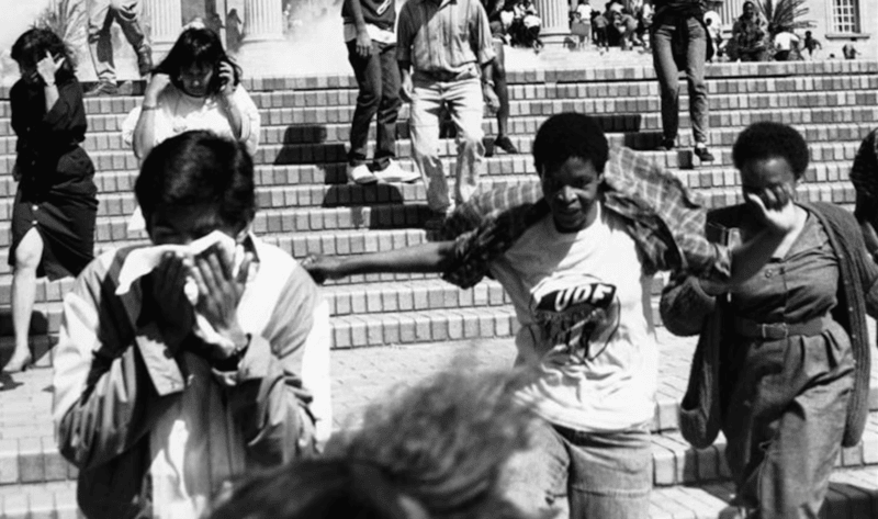 What is apartheid? New book for young readers explains South Africa’s racist system - Student demonstrators at Johannesburg's Witwatersrand University flee as police fire tear gas at them during an anti-apartheid protest in Johannesburg, August 31, 1989. REUTERS