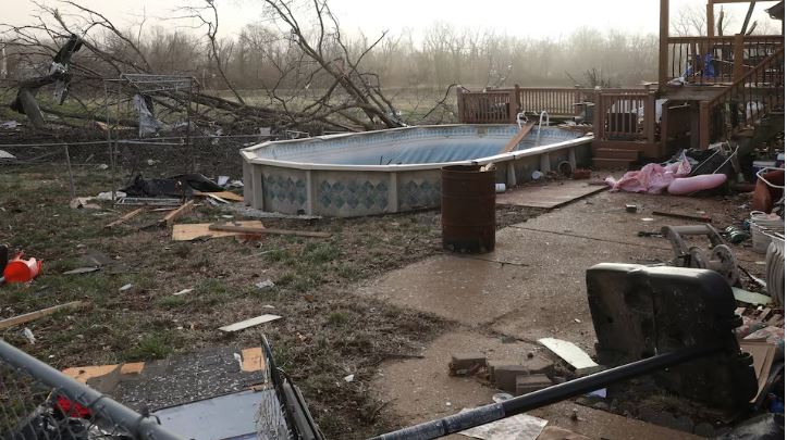 Large area of US under tornado watch with at least 34 people dead in six states - Debris lies around a damaged home the morning after a tornado touched down in Florissant, Missouri, USA on March 15. (Photo: REUTERS/Lawrence Bryant)