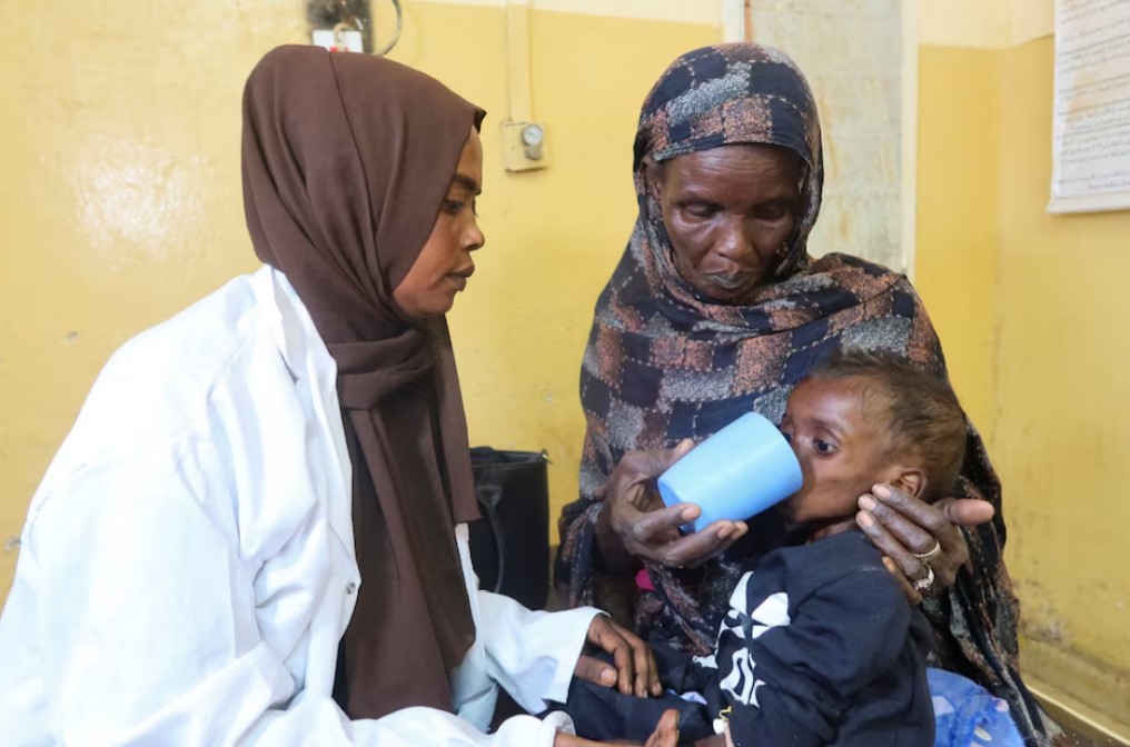 Medics struggle to revive Sudan's hungry with trickle of aid supplies - A mother feeds her child, who is suffering from malnutrition, next to a doctor in Alban Jadeed hospital, as young children struggling with malnutrition fill wards in the Sharg Elnil area, in Khartoum, Sudan, March 15, 2025. (Photo.Reuters)