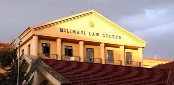Drama at Milimani Law Courts as businessman wheeled in by ambulance to face judge